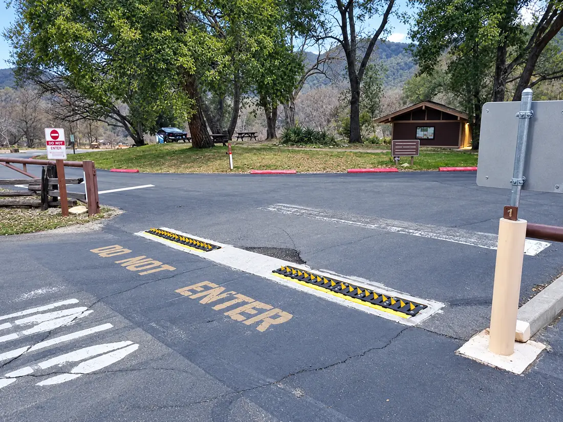 In-ground spikes behind a DO NOT ENTER stencil at a park entrance