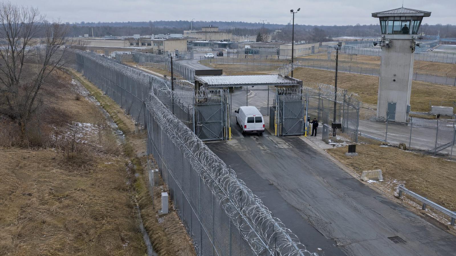 Aerial view of a correctional facility sally port with razor-wire fencing and a guard tower