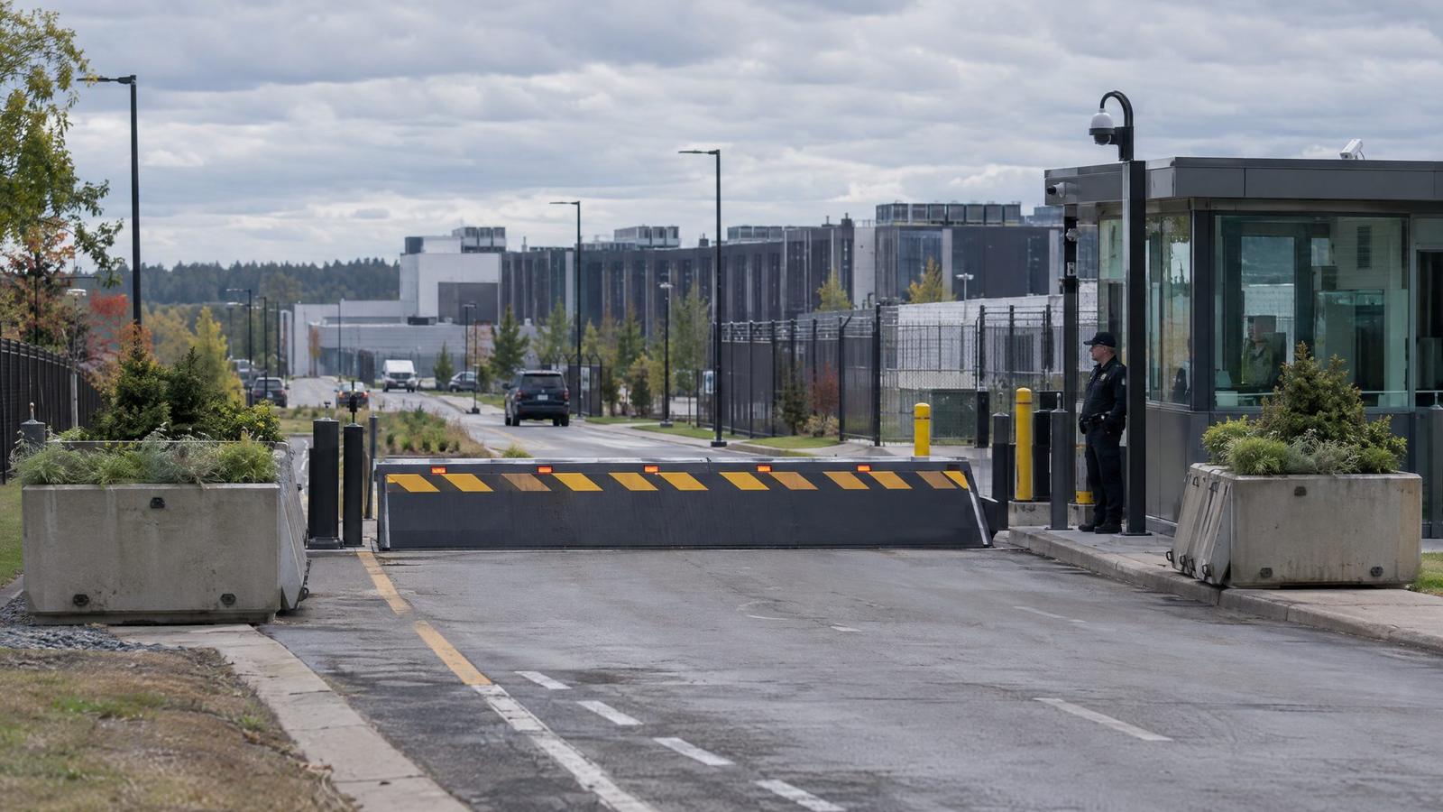Crash-rated wedge barrier in front of a guardhouse at a high-security campus entrance