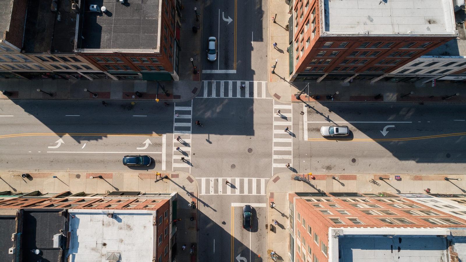 Overhead drone view of a downtown intersection with one-way street markings