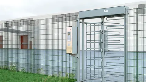 Magnetic MPT full-height turnstile set into a perimeter fence