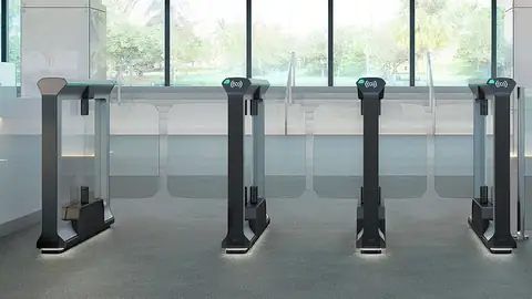 Row of Magnetic mWing optical speed gates with glass wings in a glass-walled foyer