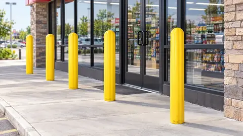 Yellow bollard covers in front of a store entrance