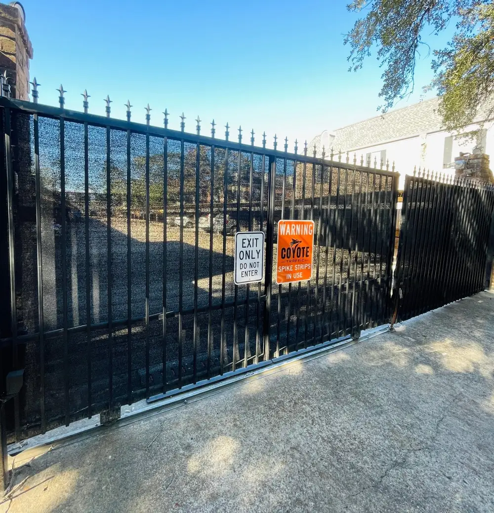 Black sliding exit gate with an Exit Only sign and an orange Coyote spike-strips warning sign, marked up as a sample layout