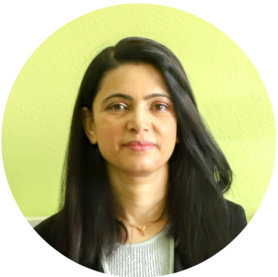 Hannah Garcia smiling, standing in front of a rental car facility with a Coyote traffic control installation visible in the background.